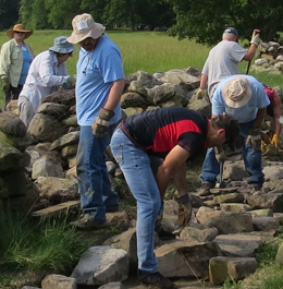 Friends of Gettysburg Volunteers help build a stone wall on the Gettysburg Battlefield